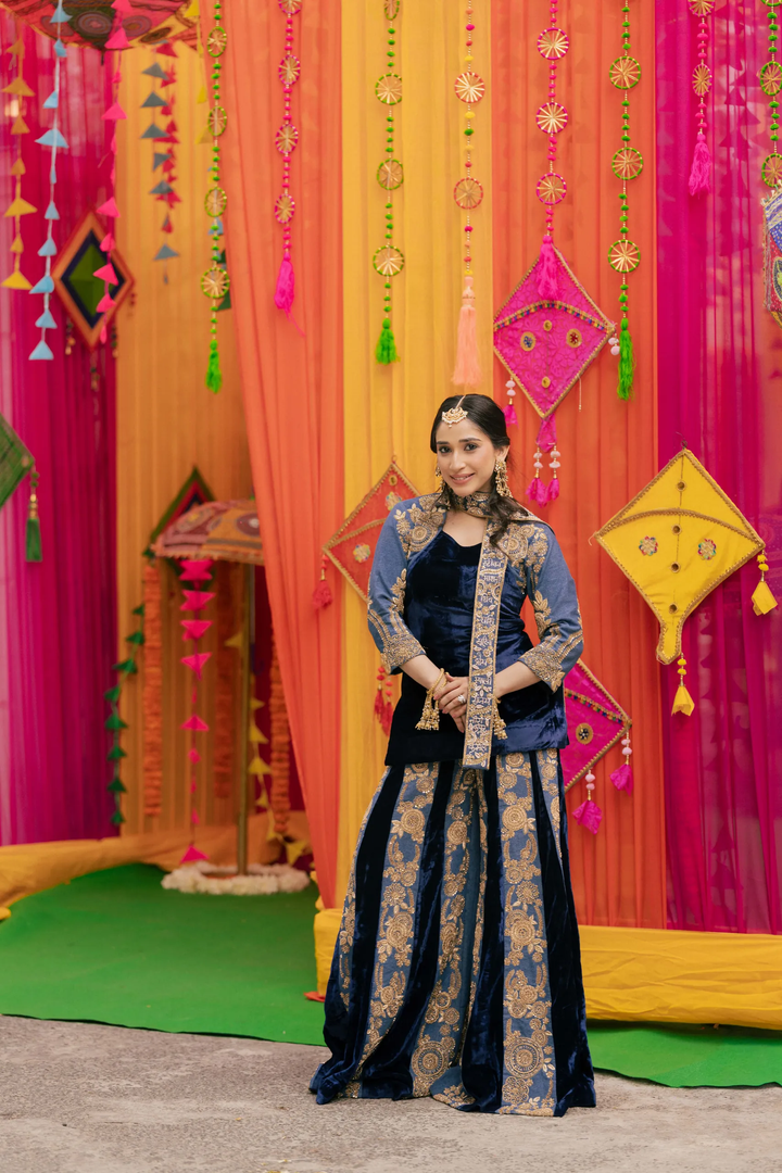 Woman in a traditional outfit standing in front of colorful festive decorations